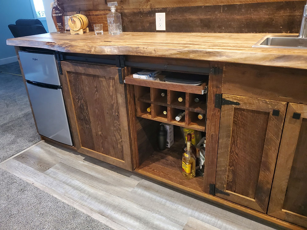 Northern Michigan reclaimed barnwood custom bar with wine rack and live edge slab bar top