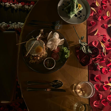 An overhead shot of a traditional Balinese Nasi Campur dish served during a private romantic dinner beside the pool at Punduk Villa's, The Manta.