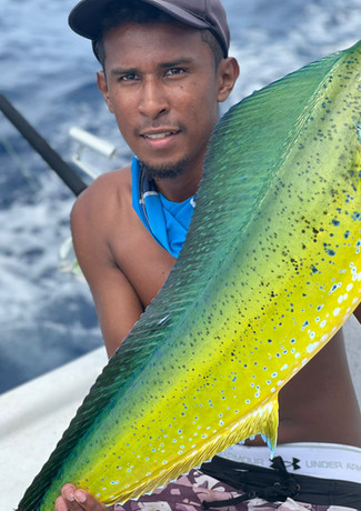 Man holding Wahoo fish in a boat Placencia