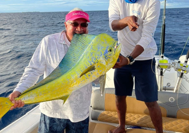 Two Men holding Wahoo fish in a boat Placencia
