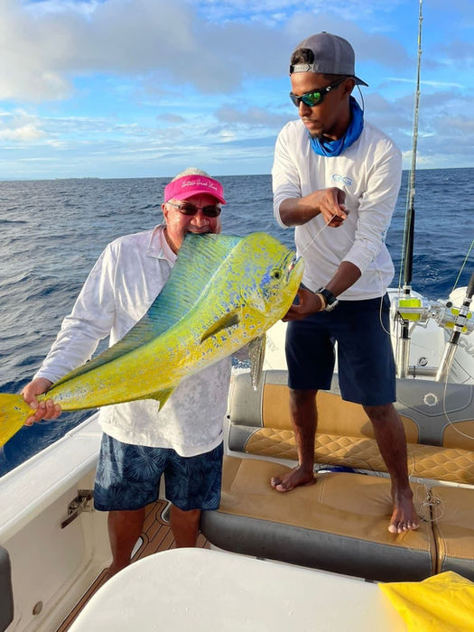 Two Men holding Wahoo fish in a boat Placencia