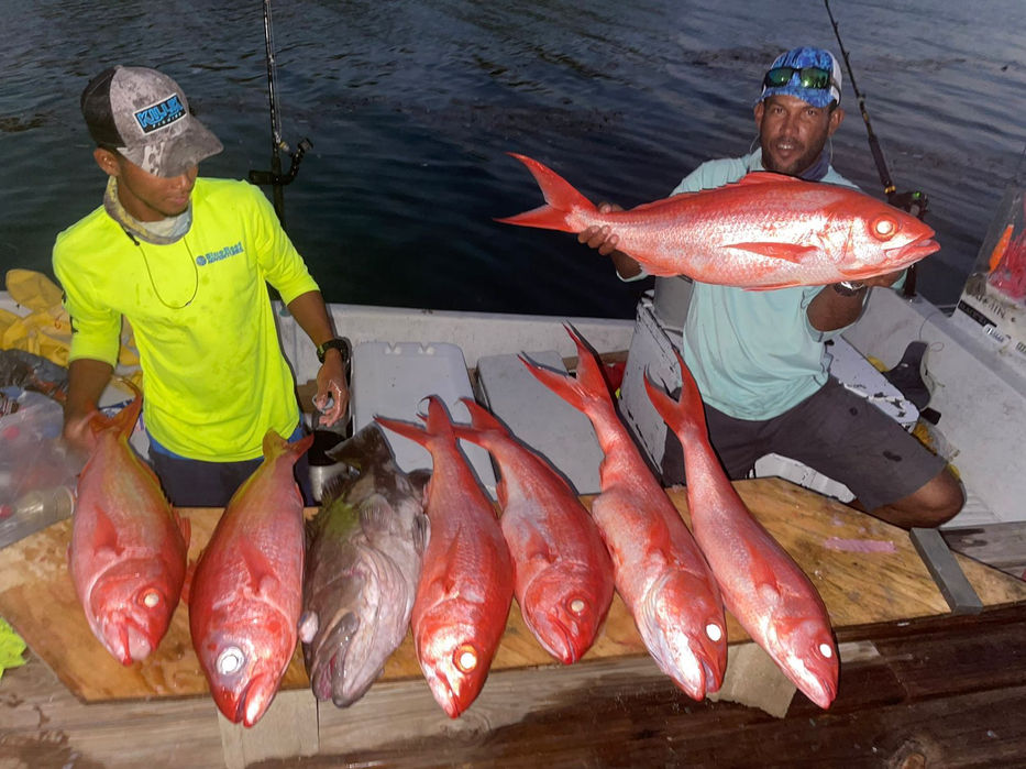 Two guys posing with Red snappers Placencia