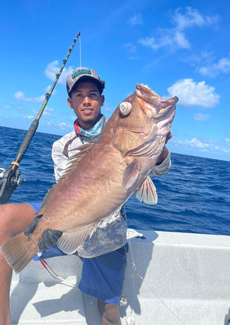 Man holding fish in a boat
Placencia