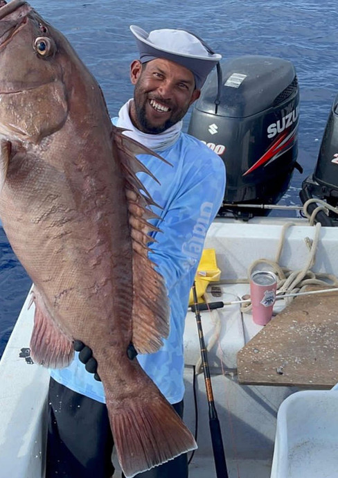 Man holding fish in a boat Placencia