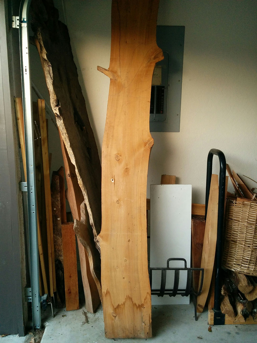 One of two halves of an unknown type of wood that my brother must have found on one of his trips. Sure wish I knew the history. I cut it in half and made two porch swings.
