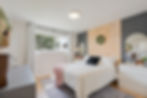 Modern bedroom captured by a real estate photographer.