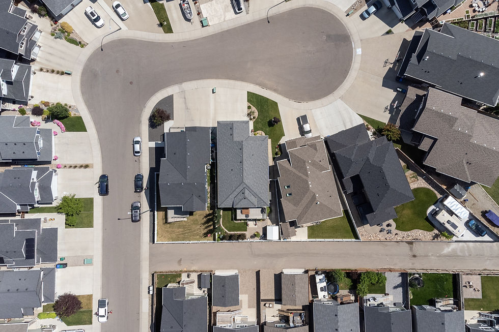 Aerial drone view of suburban homes and a cul-de-sac.
