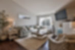 Bright living room with sofa, coffee table by real estate photographer