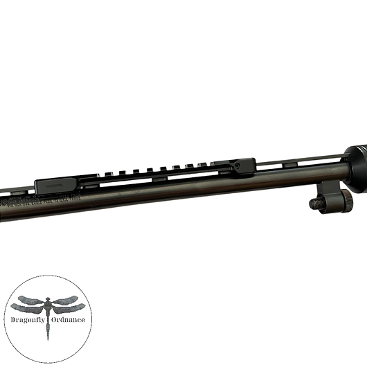 Precision-machined by Recknagel in Germany, this shotgun rib Picatinny rail provides a secure and practical way to mount a red dot sight directly onto a ventilated shotgun rib without permanent modification. Designed to clamp securely onto the rib using integrated fixing screws, it offers a lightweight and low-profile mounting solution ideal for hunting and pest control setups. This rail is particularly well suited to Mossberg .410 shotguns, including Hushpower and Stealth silenced models, where fitting a compact red dot can significantly improve target acquisition and low-light usability. The low mounting height helps maintain a natural cheek weld and intuitive sight picture while preserving the handling characteristics of the shotgun. Manufactured from durable steel with a black finish, the rail accepts standard Picatinny-compatible optics and accessories. Installation requires no drilling or permanent modification, making it an excellent option for shooters wanting a reversible optic setup. Recknagel Picatinny Rail for Shotgun Rib – Mossberg .410 Compatible, Dragonfly Ordnance UK Precision-machined by Recknagel in Germany, this shotgun rib Picatinny rail provides a secure and practical way to mount a red dot sight directly onto a ventilated shotgun rib without permanent modification. Designed to clamp securely onto the rib using integrated fixing screws, it offers a lightweight and low-profile mounting solution ideal for hunting and pest control setups. This rail is particularly well suited to Mossberg .410 shotguns, including Hushpower and Stealth silenced models, where fitting a compact red dot can significantly improve target acquisition and low-light usability. The low mounting height helps maintain a natural cheek weld and intuitive sight picture while preserving the handling characteristics of the shotgun. Manufactured from durable steel with a black finish, the rail accepts standard Picatinny-compatible optics and accessories. Installation requires no drilling or permanent modification, making it an excellent option for shooters wanting a reversible optic setup. Recknagel Picatinny Rail for Shotgun Rib – Mossberg .410 Compatible, Dragonfly Ordnance UK