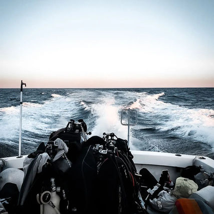 An Instigator diving vessel with scuba tanks and diving equipment setup on the Atlantic Ocean with waves