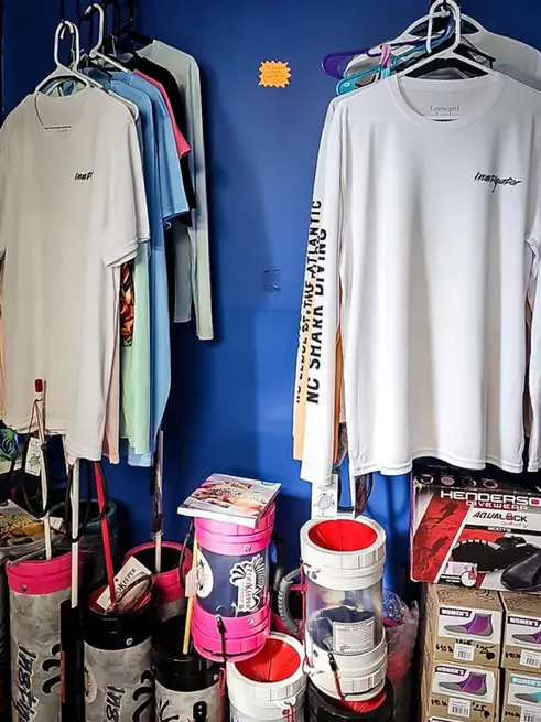 Instigator fishing and diving retail shop with shirts and lionfish hunting equipment by zookeeper on display