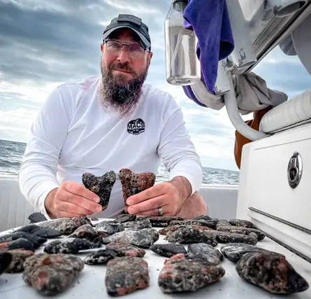Instigator customer with a selection of Megalodon teeth he found during his dives in North Carolina