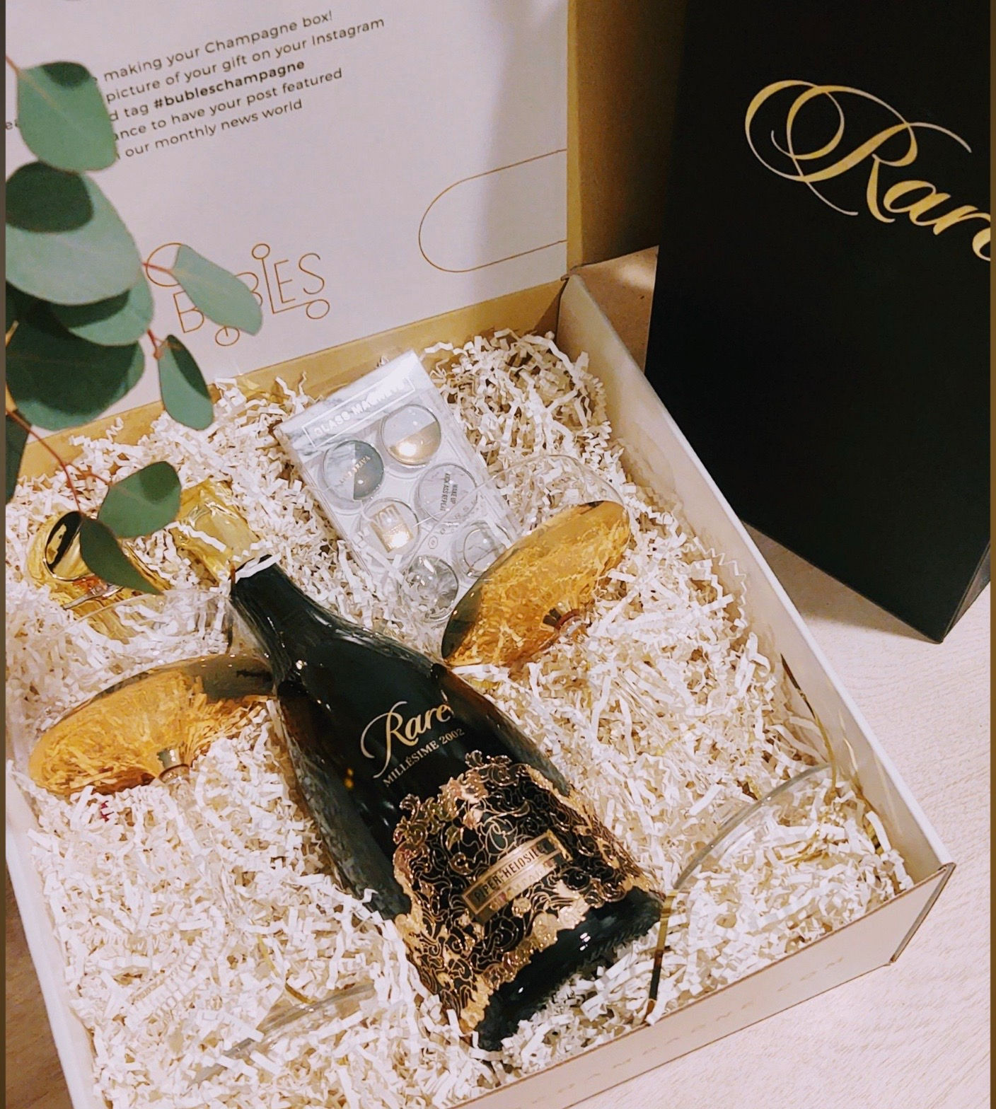 Elegant gift box: Rare wine, earrings, and pastries