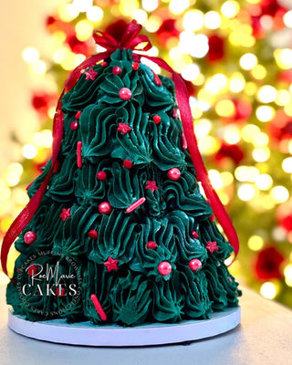 Green Christmas tree cake with red ribbon
