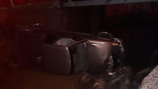 Pickup truck ends in stream after crashing off bridge