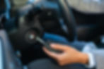 A driver inserting a key into a car ignition, providing lost car key replacement service in Revere, MA.