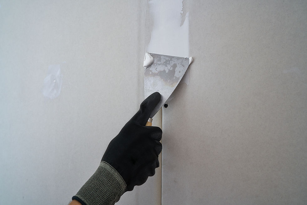Color Works contractor performing wall repair with putty knife
