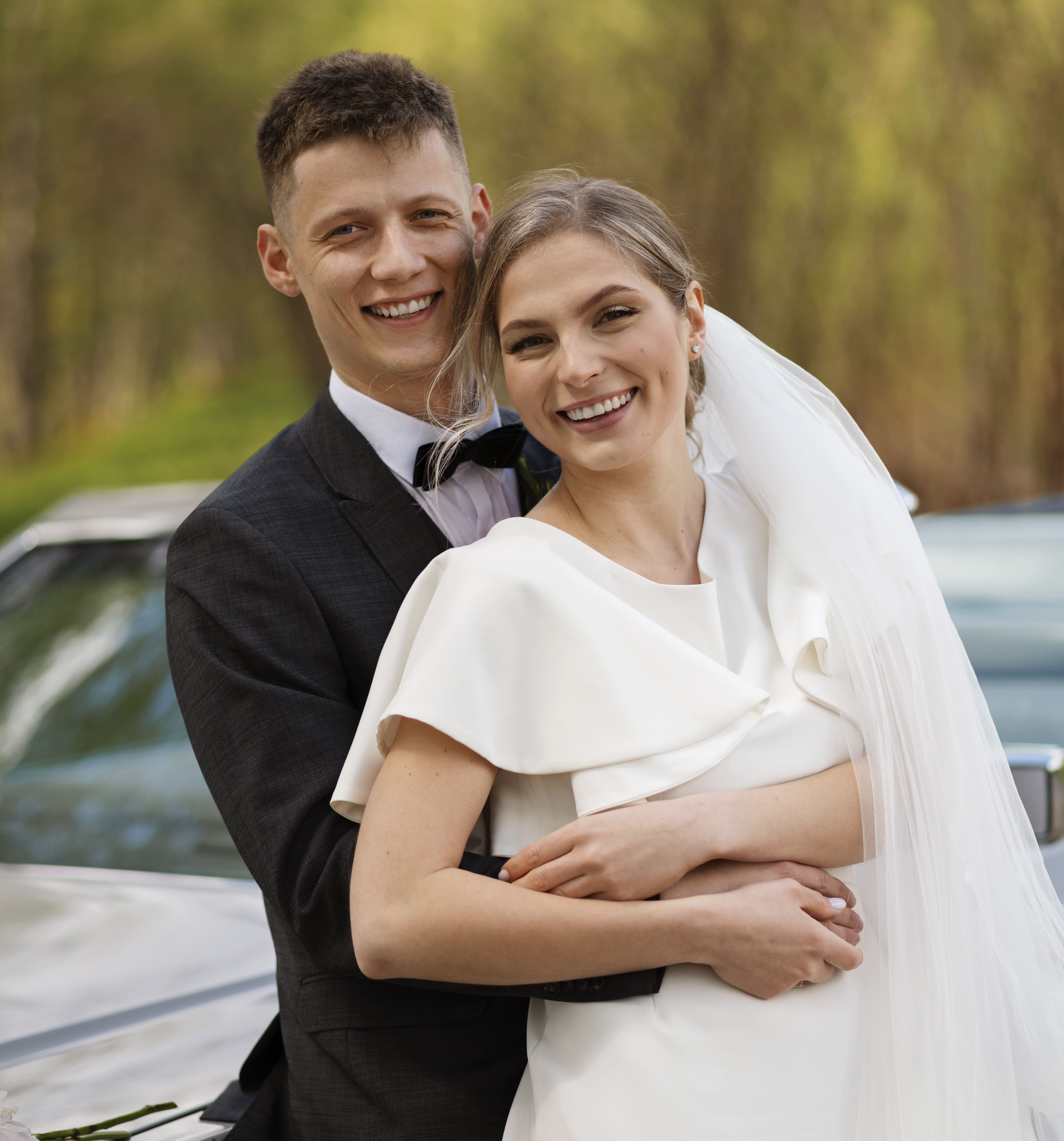 Just married couple with their wedding car