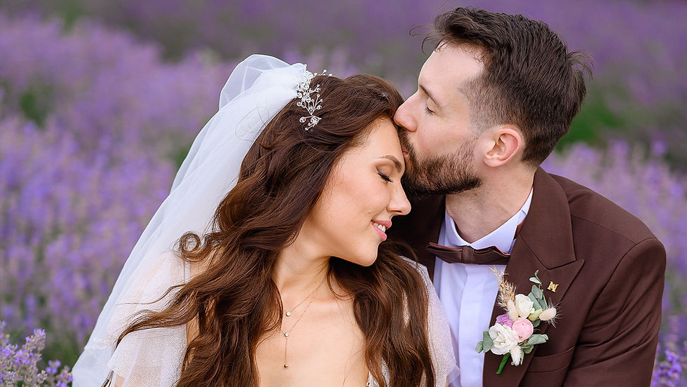 Loving newlyweds posing in a lavender meadow, hugging