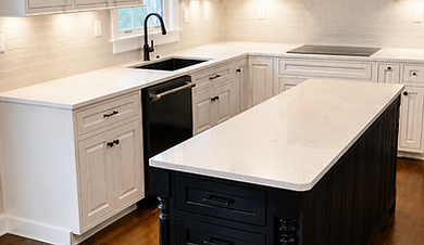 White kitchen with a black island and wood floors