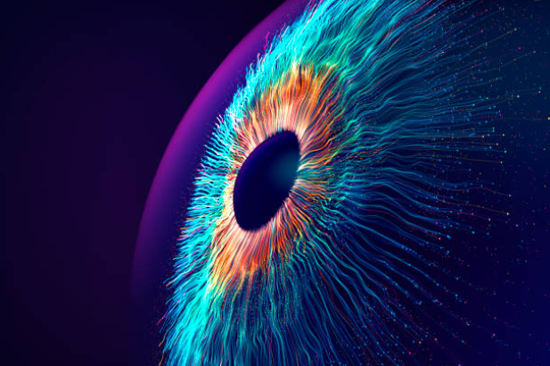 Abstract representation of an eye with vibrant blue, orange, and green colors radiating from the pupil on a dark background demonstrating AI Computer Vision