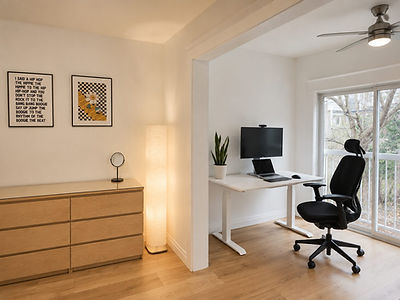 Modern home office with standing desk and black chair