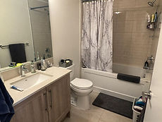 Modern bathroom renovations Toronto featuring a wood vanity.
