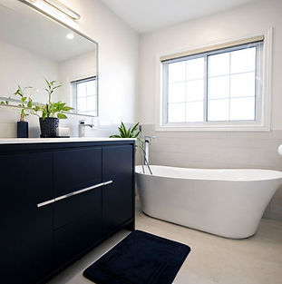 Modern bathroom renovations Toronto with tub and black vanity