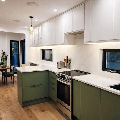New kitchen renovation with green lower cabinets and white upper cabinets