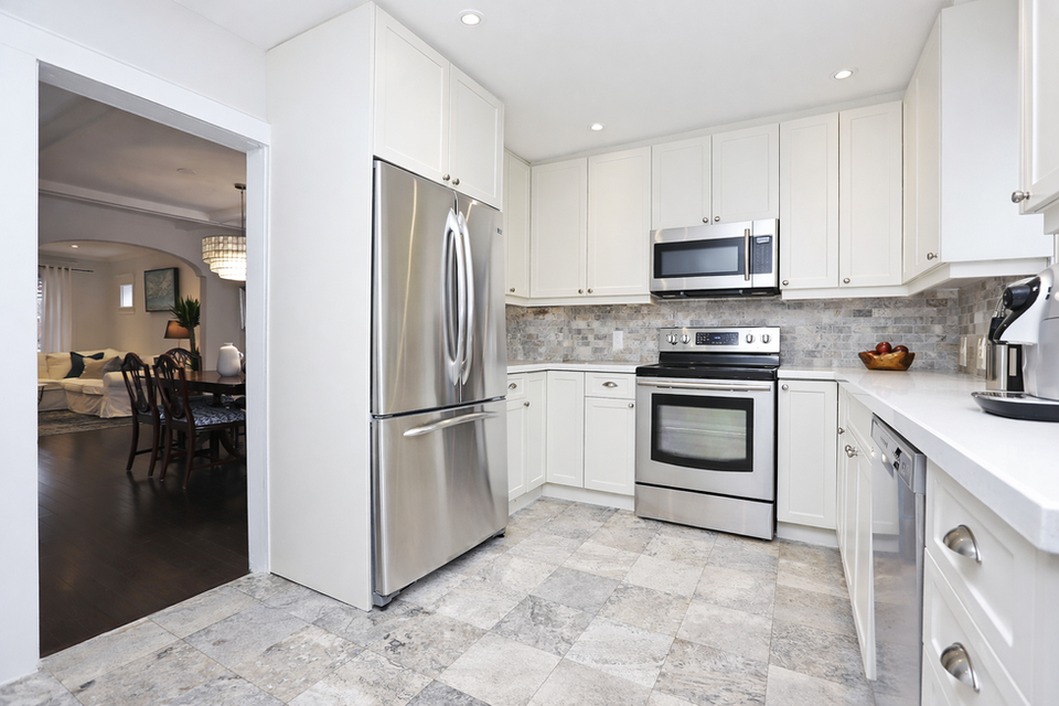 Modern kitchen renovation with light cabinets and open layout