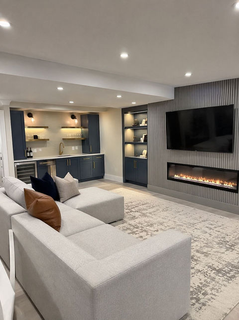 Renovated basement with fireplace and white sofa in toronto