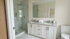 Modern bathroom renovations Toronto with white vanity and glass shower