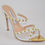 Thumbnail: White leather and lace Stiletto sandal mule with gold metallic toe insole piece design and gold studded straps