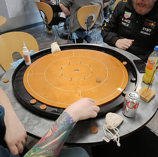 Two people playing crokinole