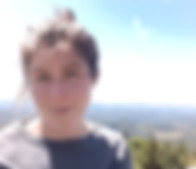 Hope Fillingim is a white woman with straight brown hair pulled into a messy bun. She is wearing a gray t-shirt.