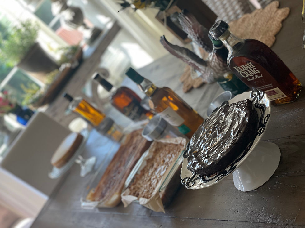 A table with desserts and whiskey