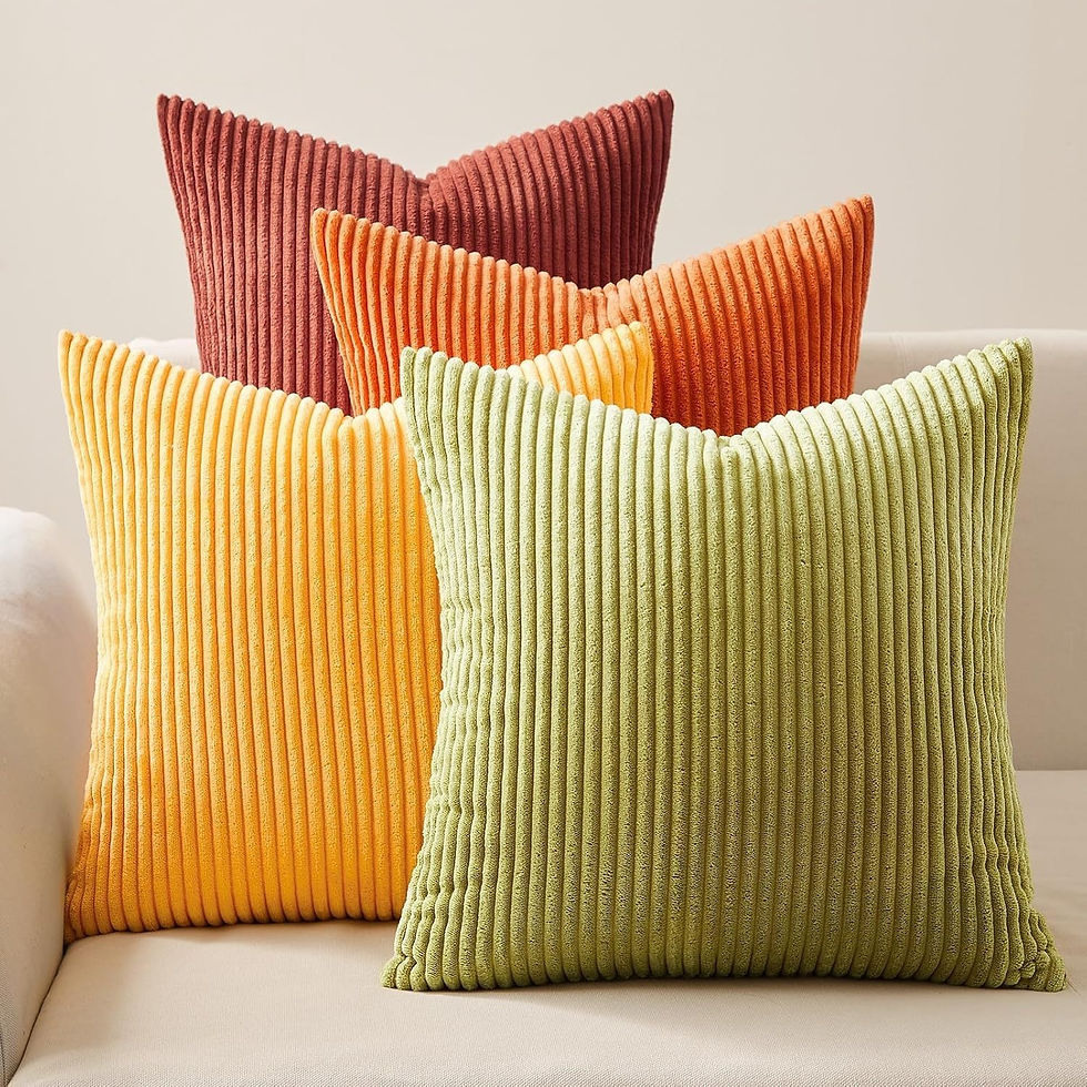 Thumbnail: Four ribbed throw pillows in autumn colors on a sofa