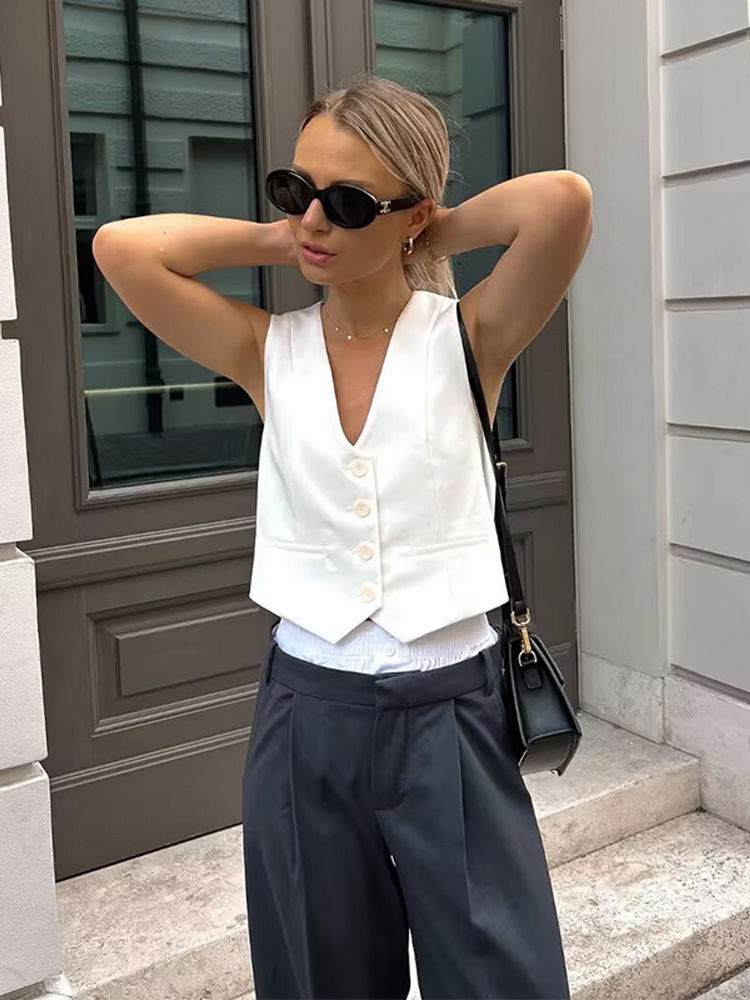 Woman in white vest and retro sunglasses