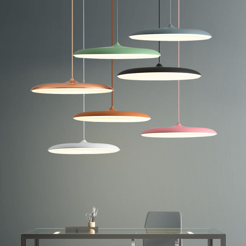 Modern colorful disc pendant lights over a table