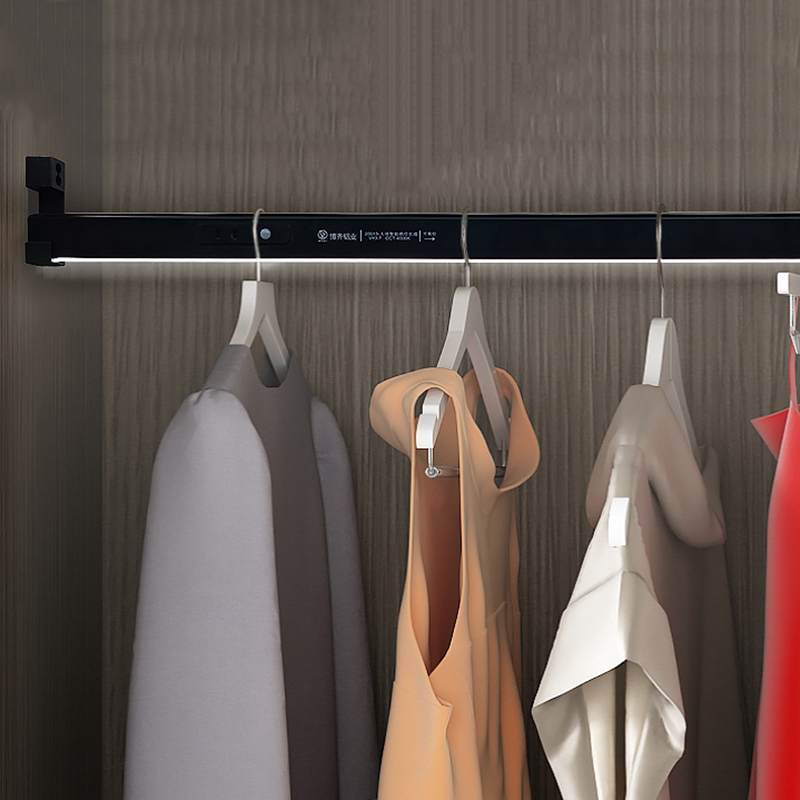 Clothes on hangers in a lit closet