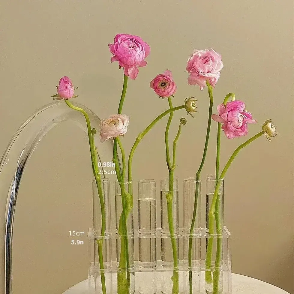 Thumbnail: Pink ranunculus flowers in clear glass tube vases