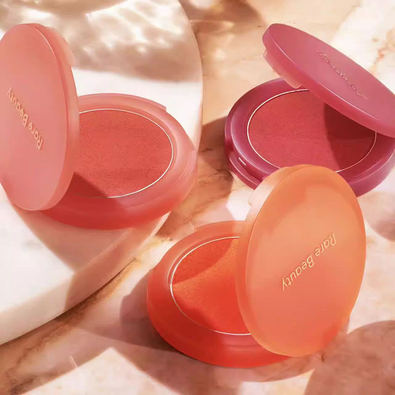 Makeup compacts with peach, rose, and orange blush