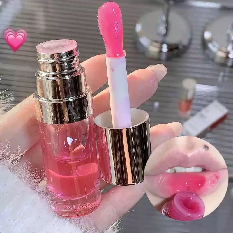 Pink lip gloss bottle with applicator and glossy lips