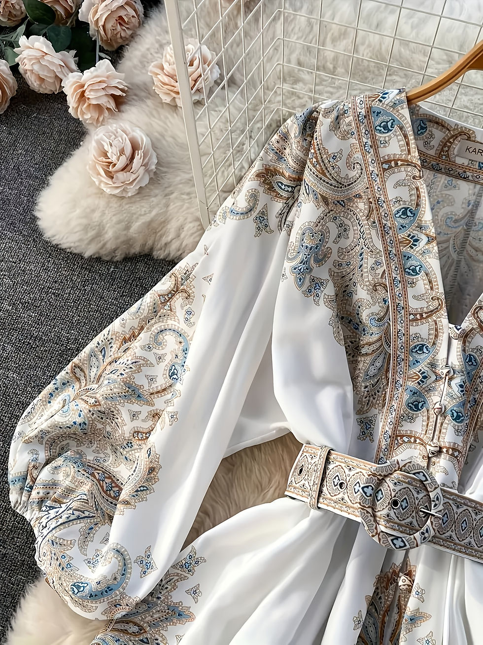 Thumbnail: Detail of paisley print V-neck dress, lantern sleeve, and belt