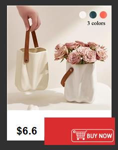 Thumbnail: White vase bags with brown handles, one filled with pink roses