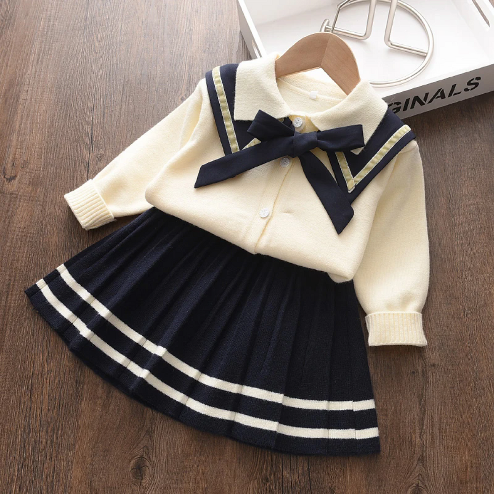 Cream top, navy collar & bow, pleated skirt with stripes