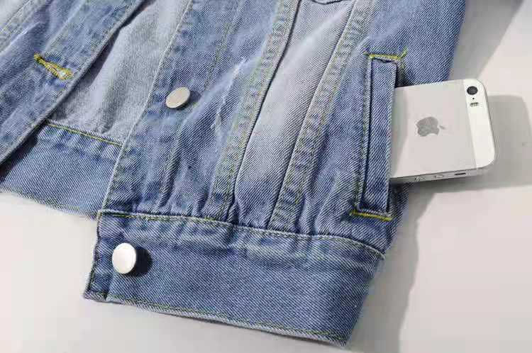 Thumbnail: Close-up of a denim jacket pocket with a smartphone