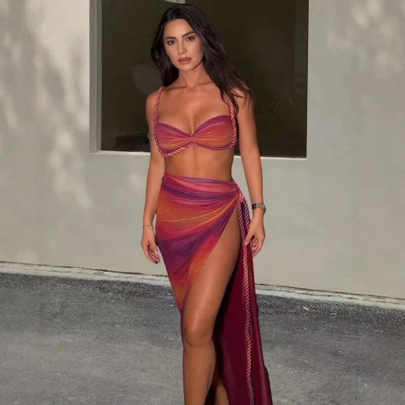 Woman in colorful striped two-piece with high-slit skirt