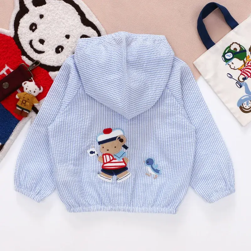 Thumbnail: Back of light blue hooded jacket with embroidered sailor and bird