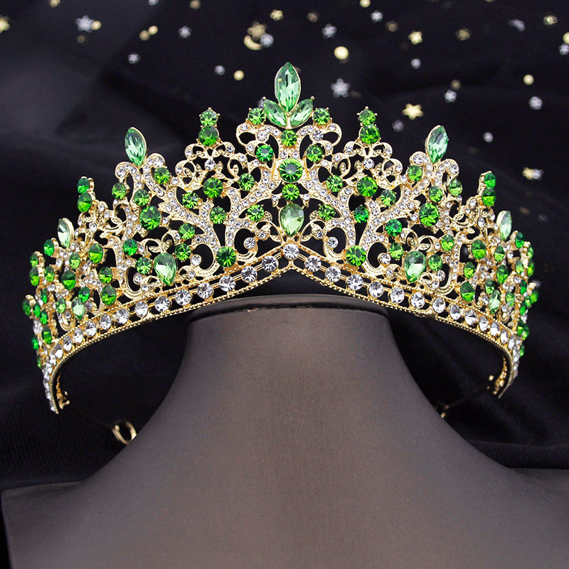 Golden crown with green and clear jewels